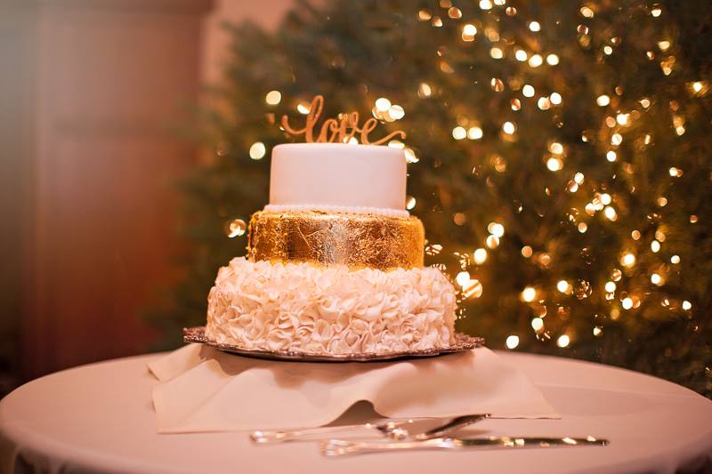 a white and gold 3-tier holiday cake