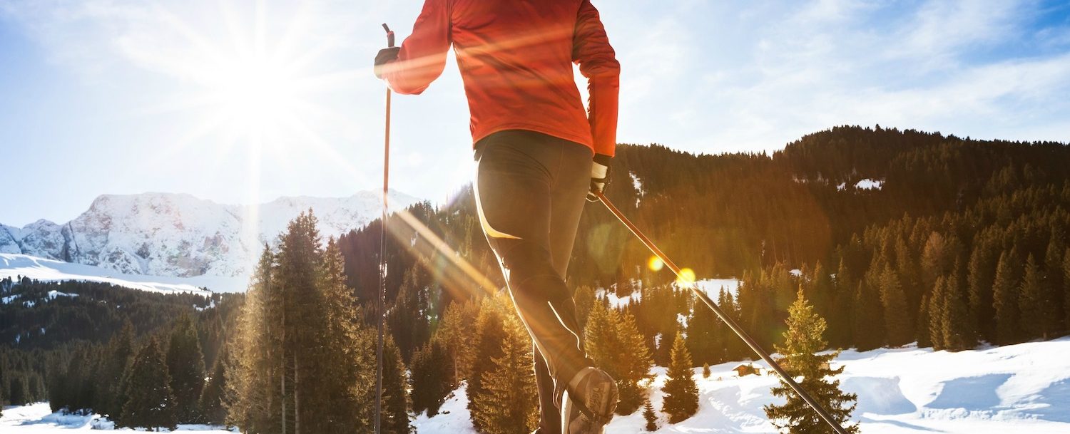 a man cross country skiing on a sunny, cold morning