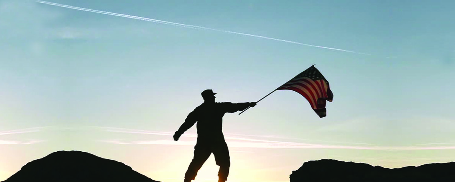 military servicemember holds flag