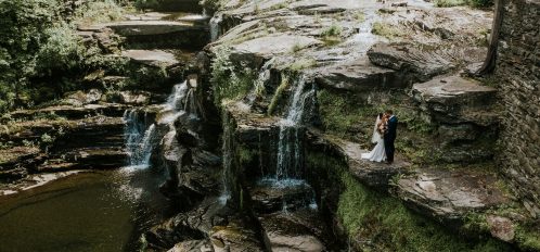 wedding couple embrace on the cliffs