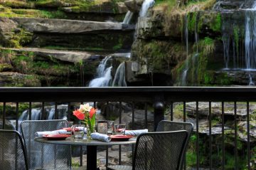 a dinner table near the waterfall